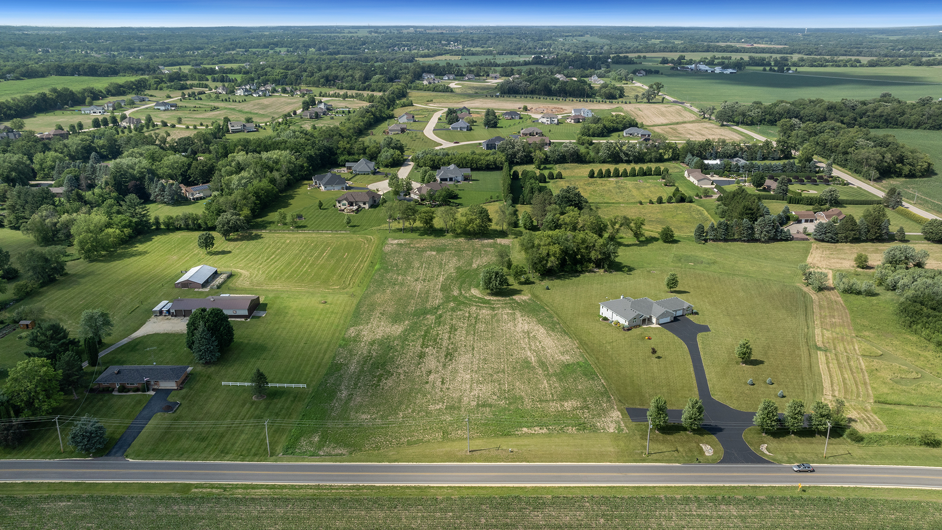 an aerial view of a houses with a yard