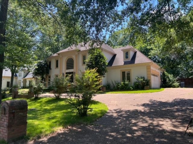 a house that has a tree in front of it