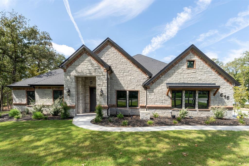 a view of a house with a yard patio and fire pit