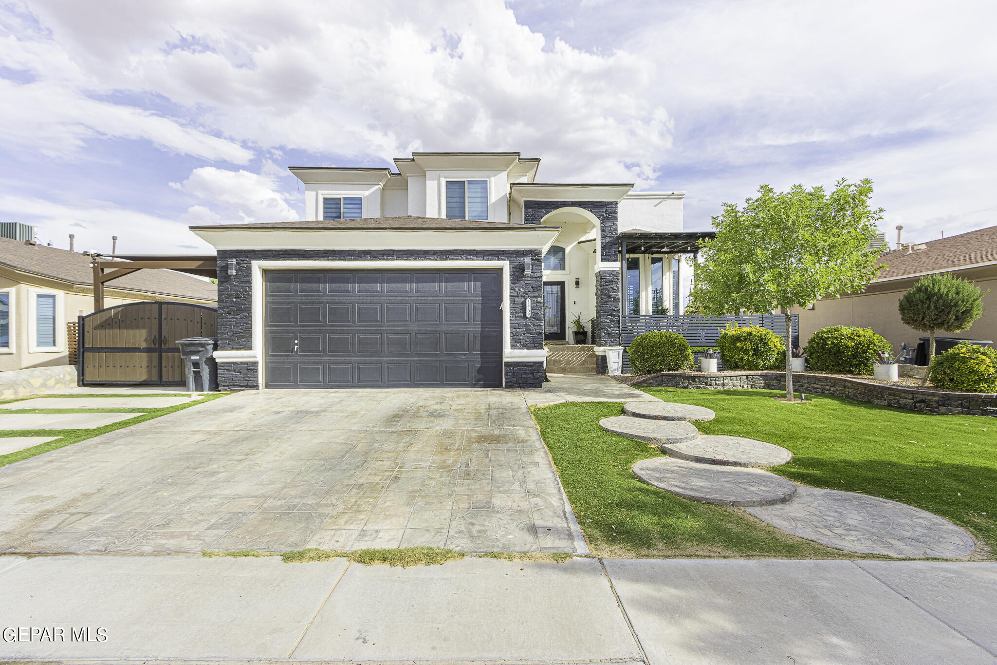 a front view of a house with a garden and yard