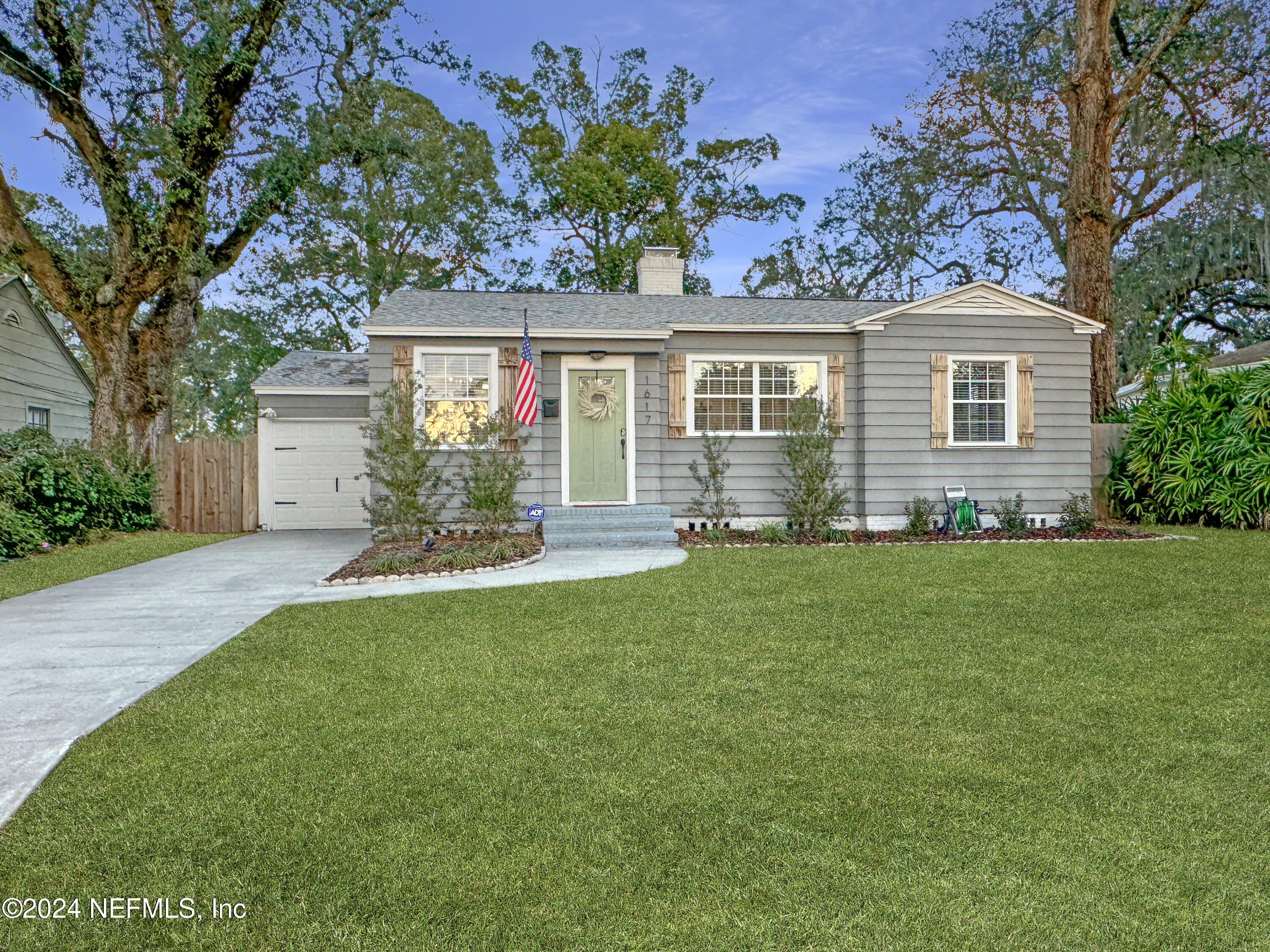 a front view of house with yard and green space