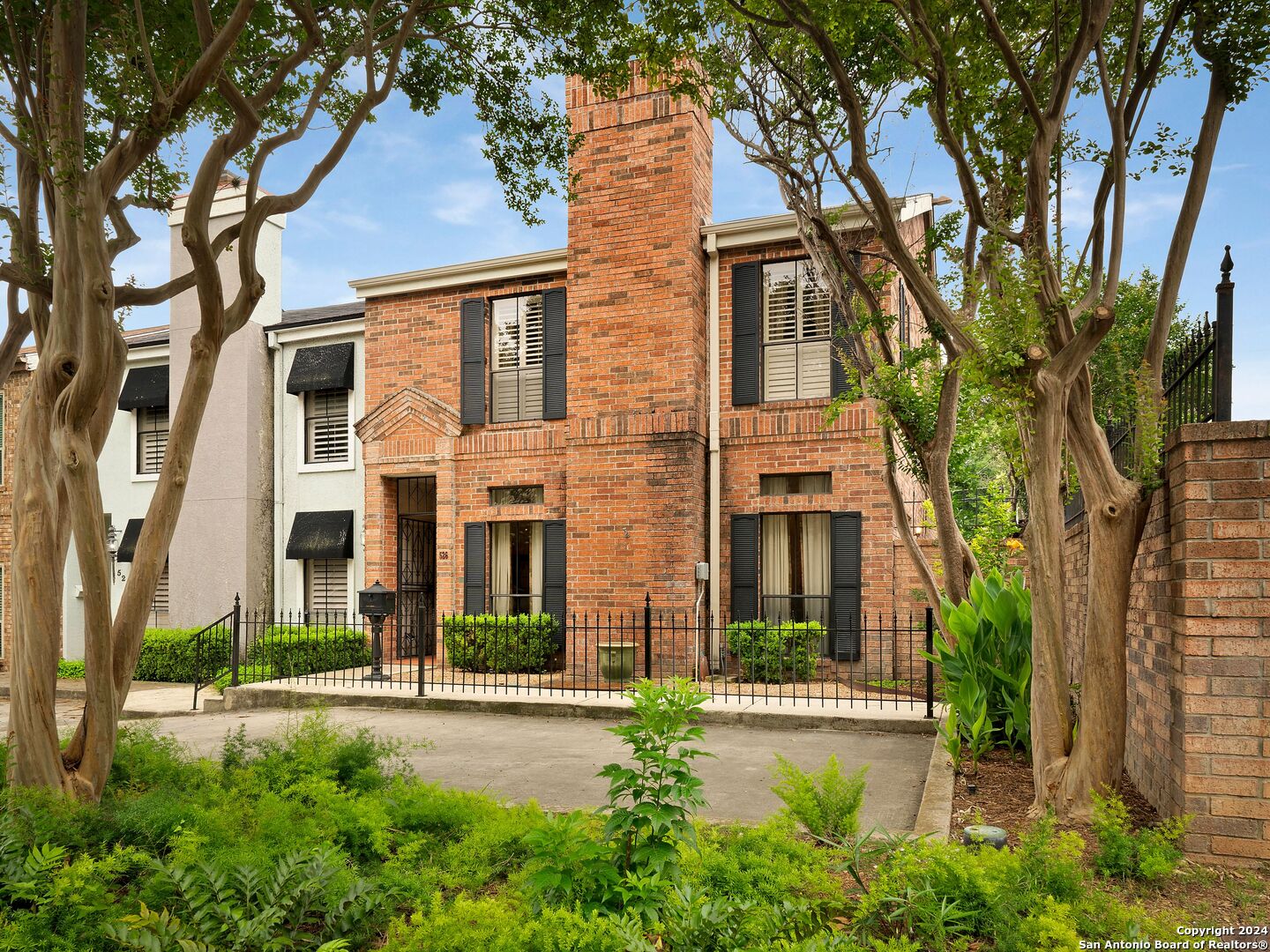 front view of a brick house with a large windows