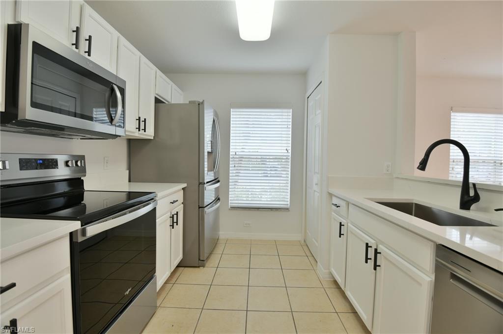 a kitchen with stainless steel appliances granite countertop a sink and a stove