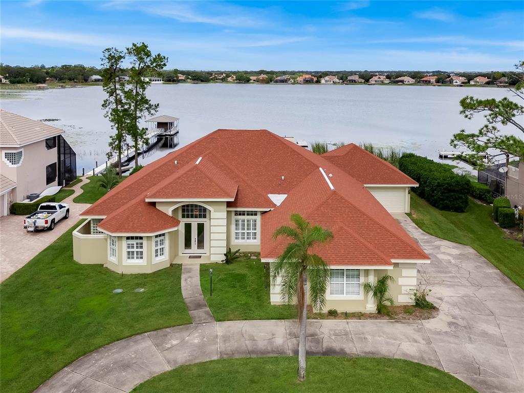 a view of a house with a yard and lake view