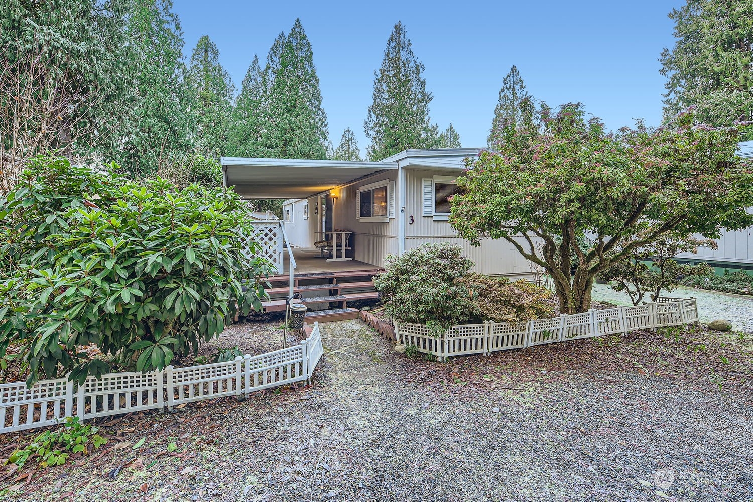 a view of a house with a small yard and wooden fence