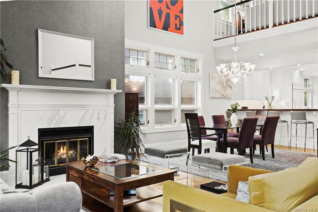 a living room with furniture dining table and a fireplace