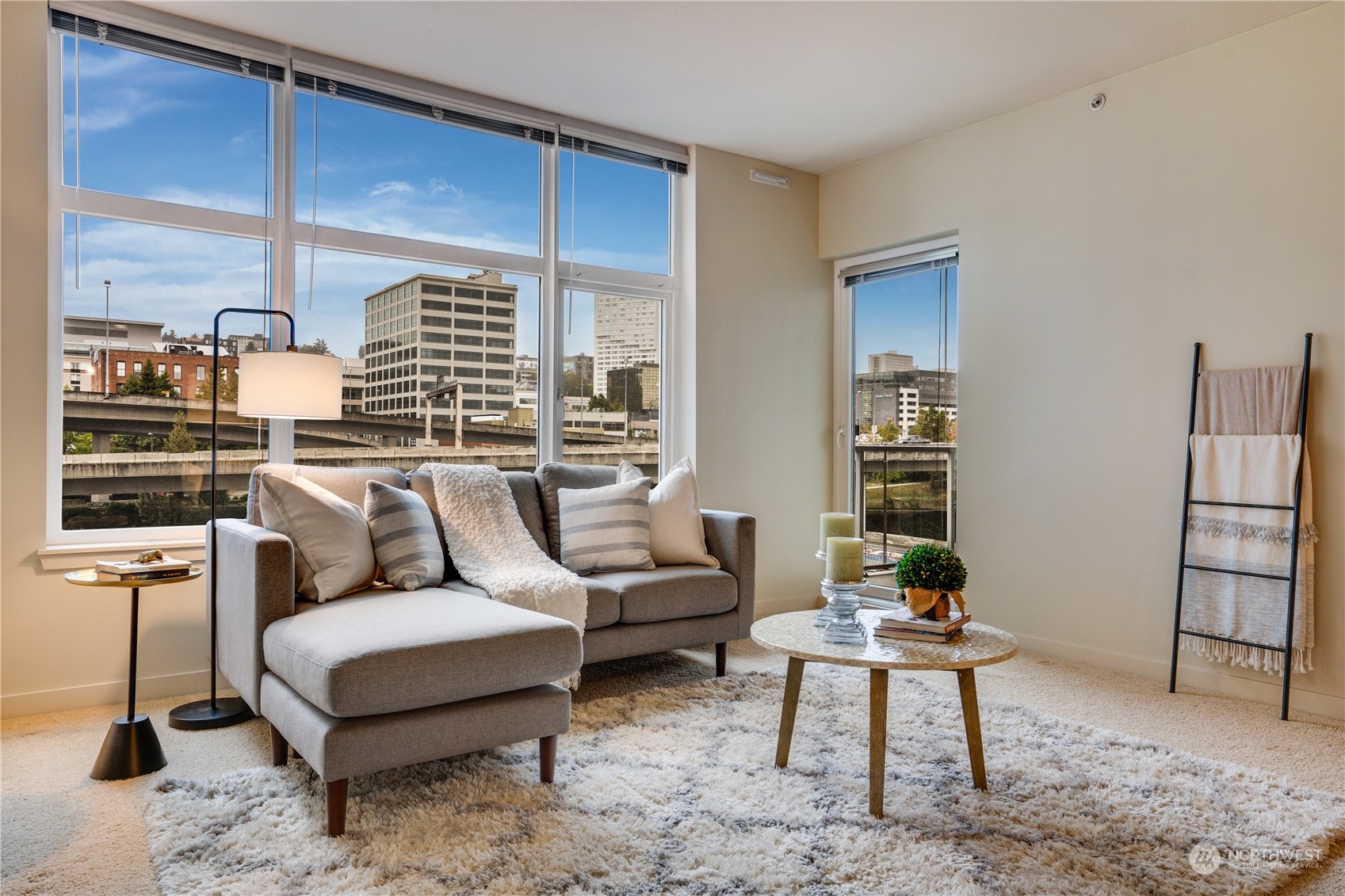 a living room with furniture a rug and a table