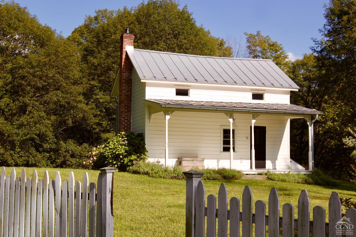 a view of a house with wooden fence