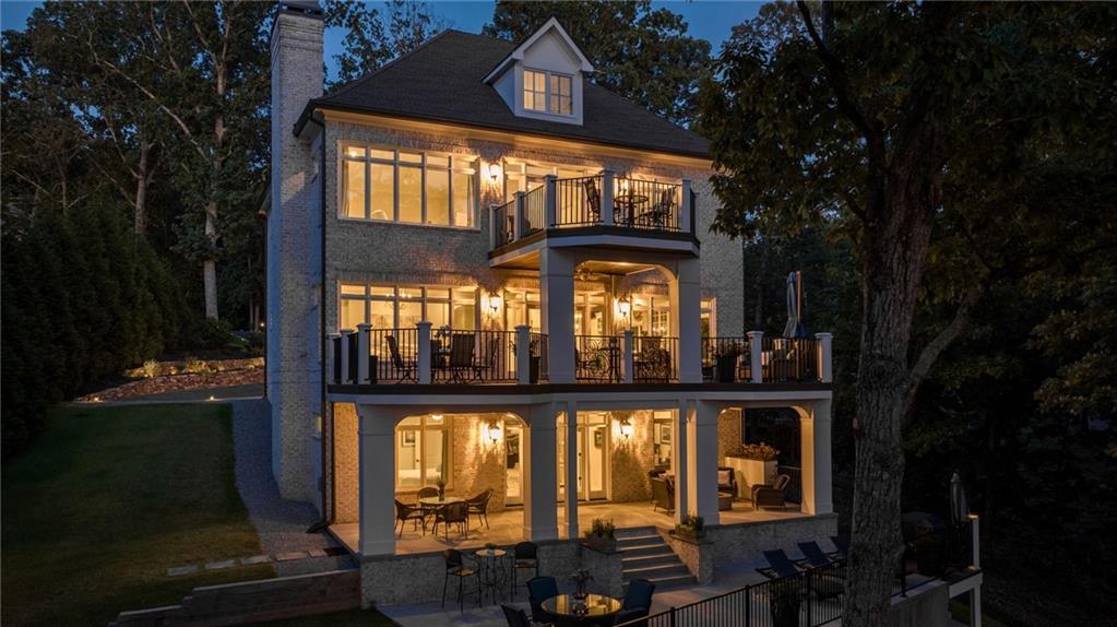 a front view of a house with outdoor space and a lake view