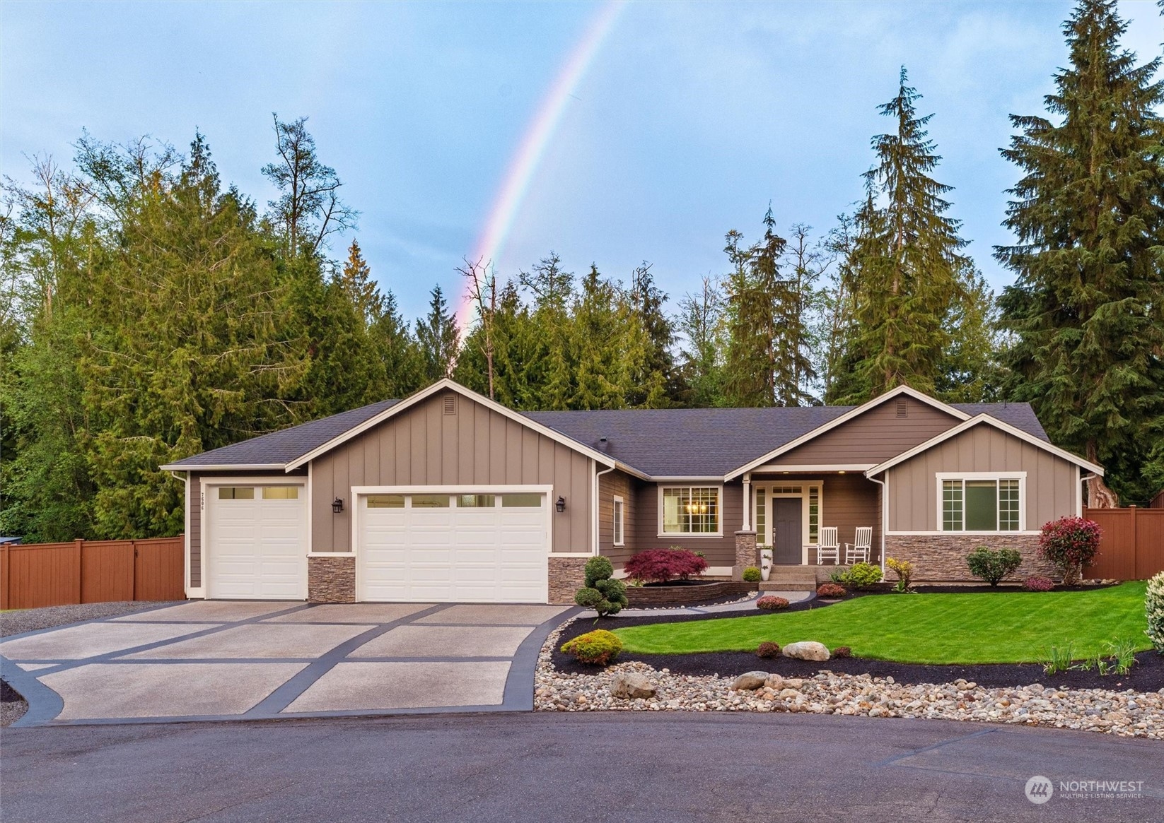 a view of front of house with a yard and garage