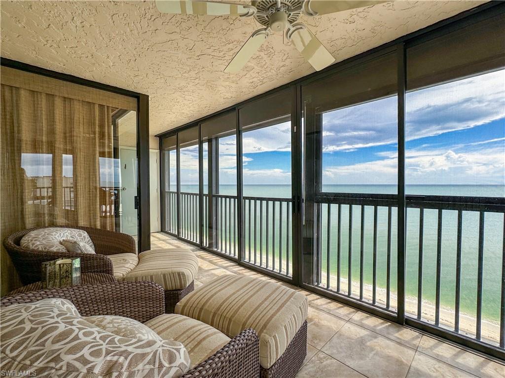 a balcony with furniture and large windows