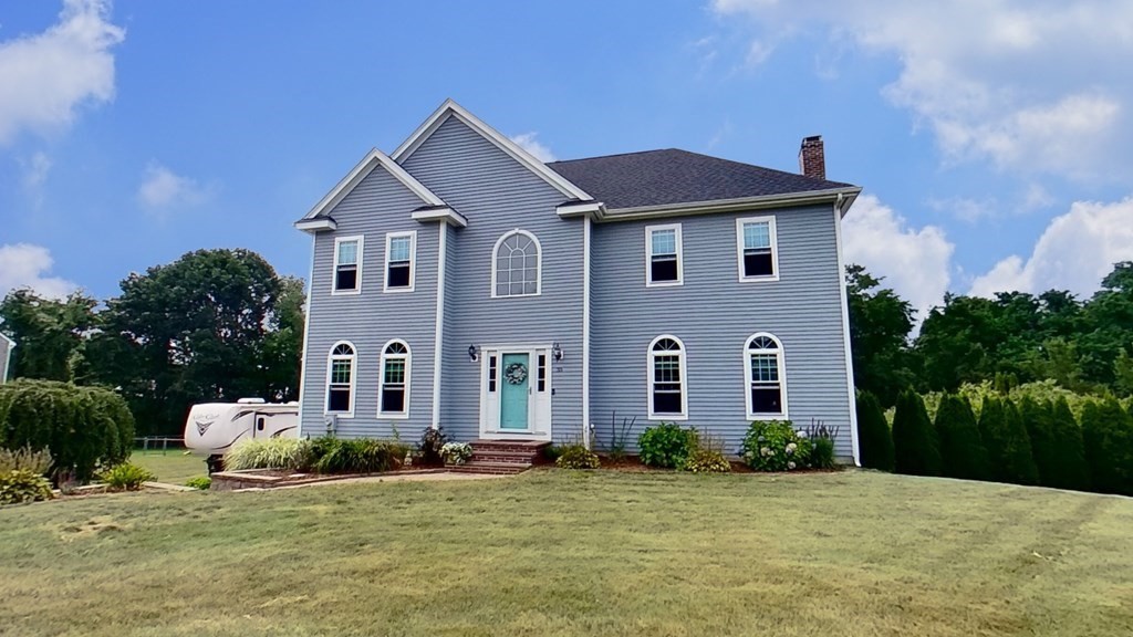 a front view of a house with a yard