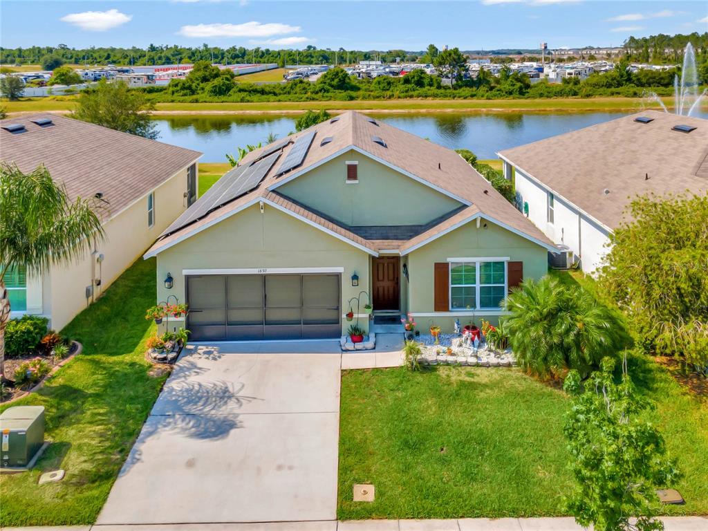 an aerial view of a house with a swimming pool yard and lake view