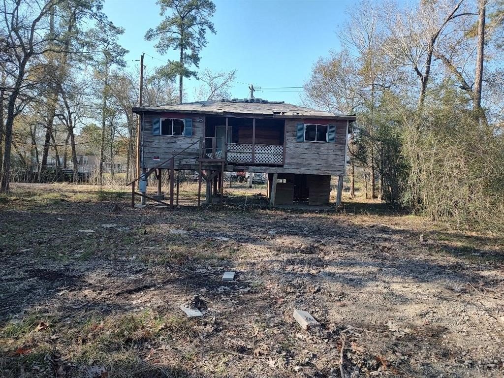 a view of a house with a yard and hanging chair