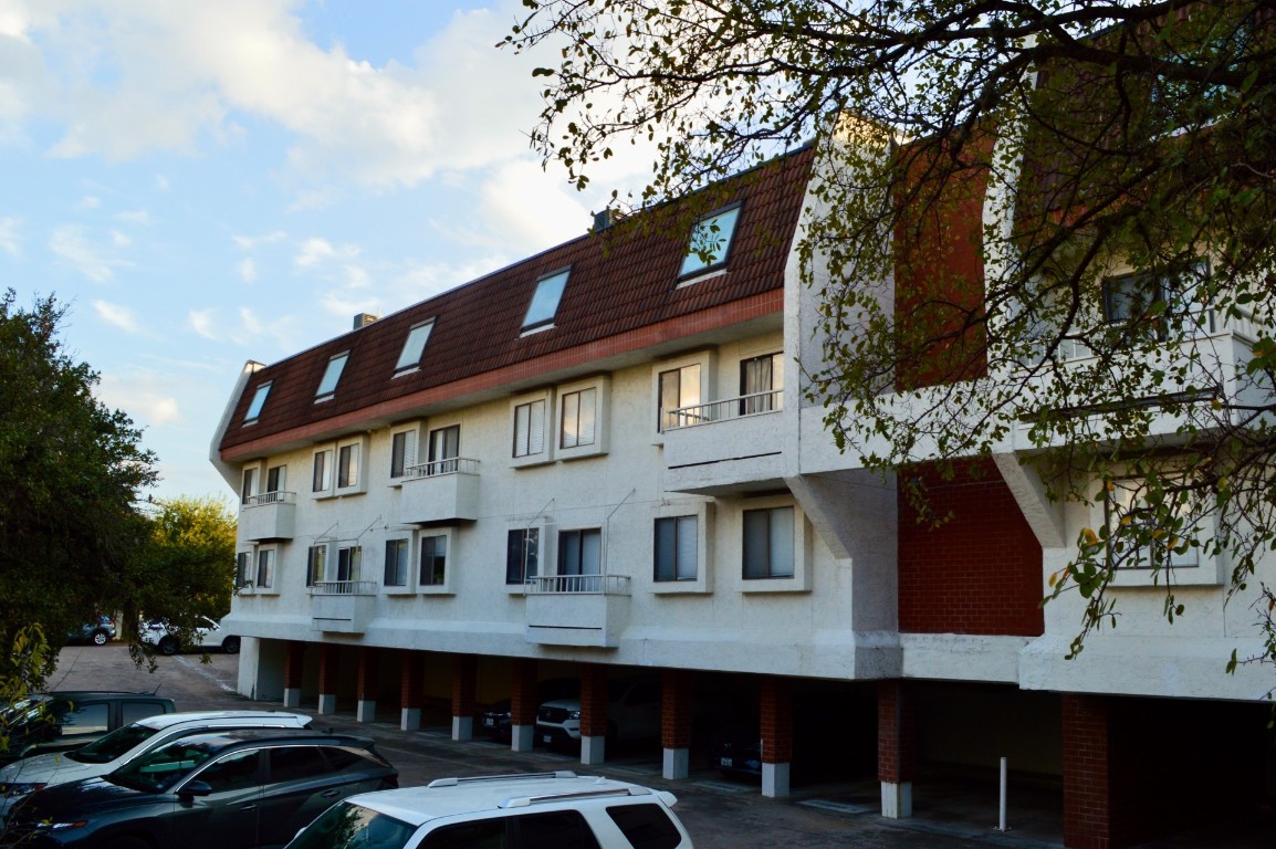 a view of a building with a lot of cars windows