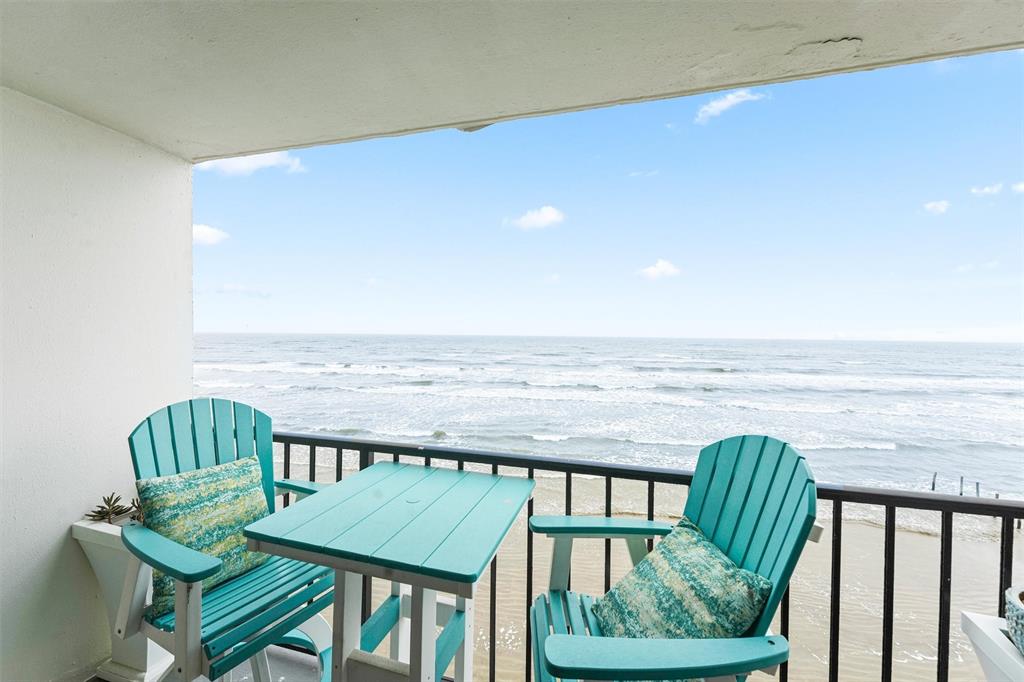 a view of a balcony with furniture and outside view