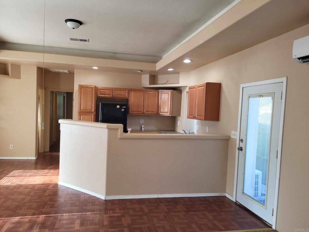 a kitchen with stainless steel appliances kitchen island granite countertop a refrigerator and a sink