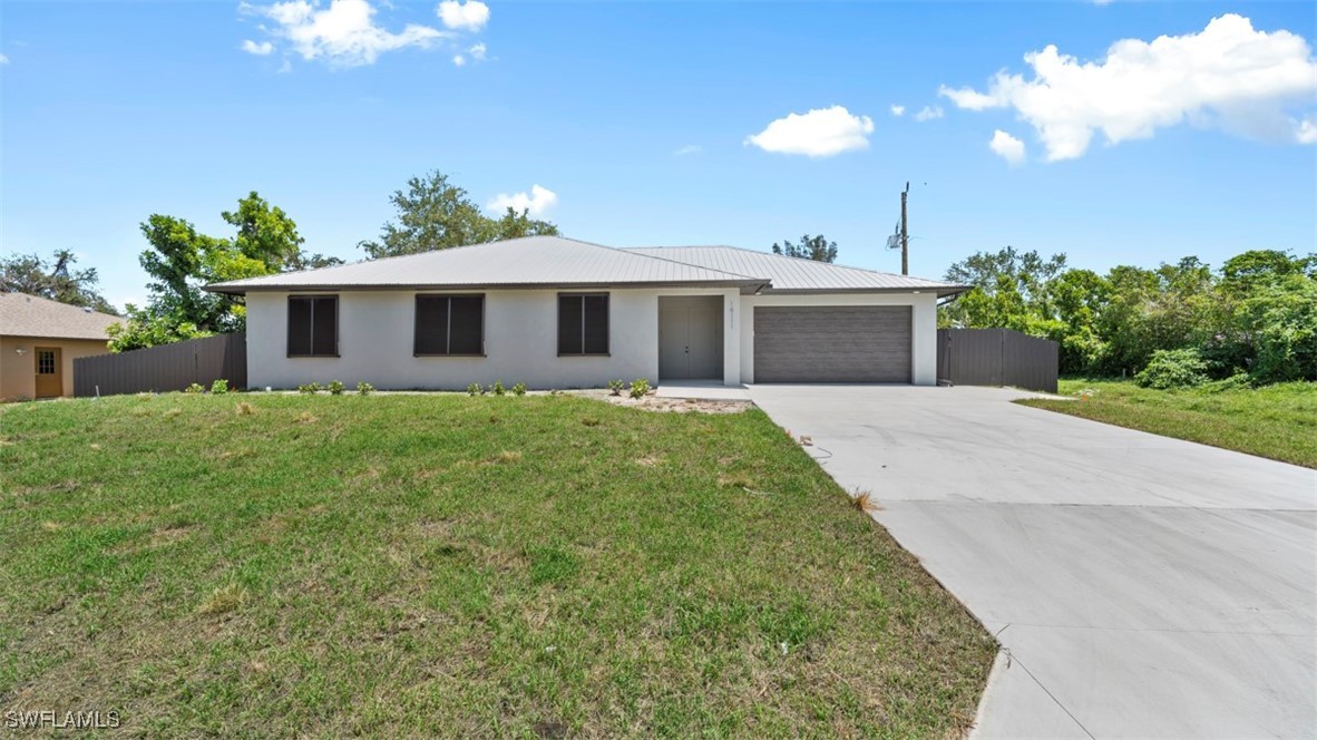 a front view of a house with yard and green space