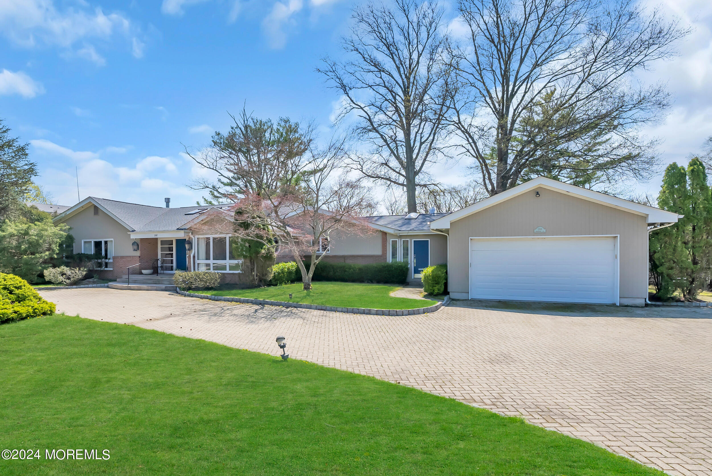 a front view of house with yard and green space