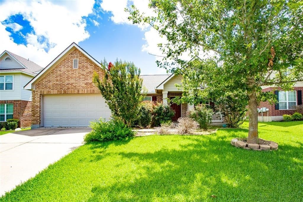 a view of a house with a yard and tree s