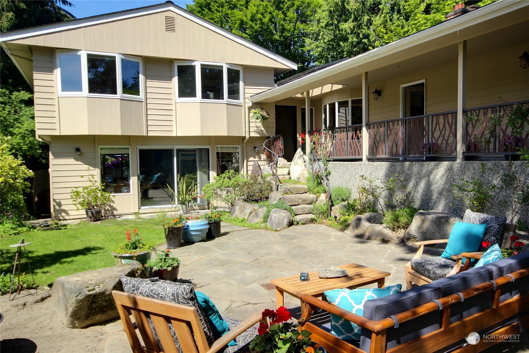 a view of a patio with table and chairs and potted plants