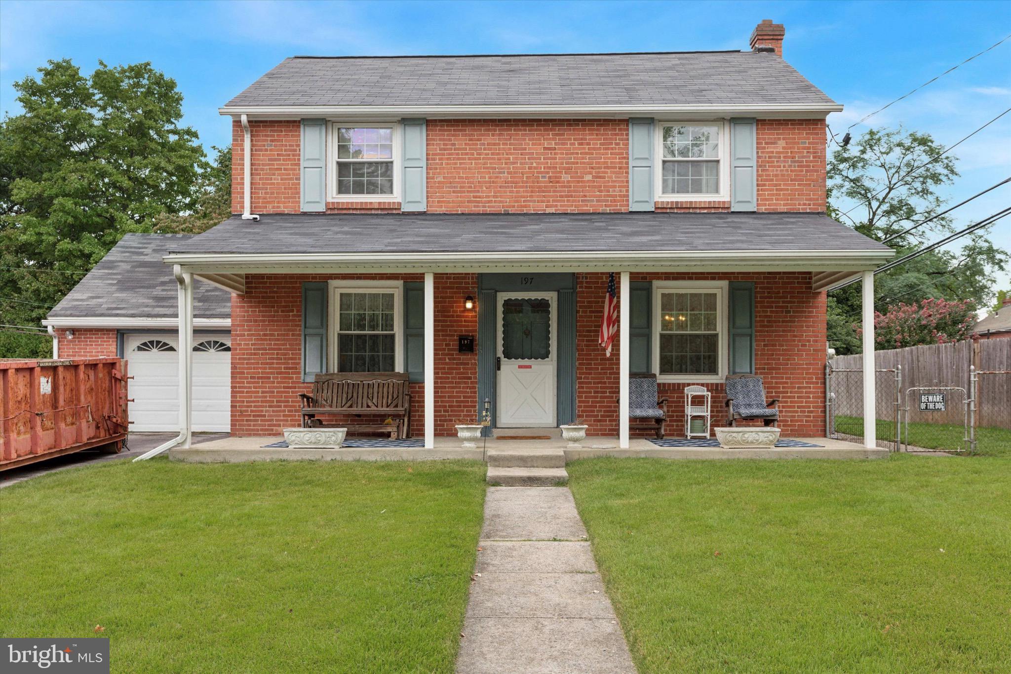 a front view of a house with a yard and porch