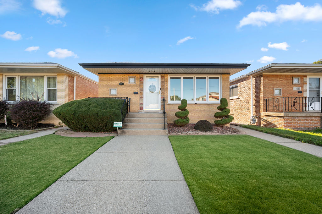 a front view of house with yard barbeque and outdoor seating