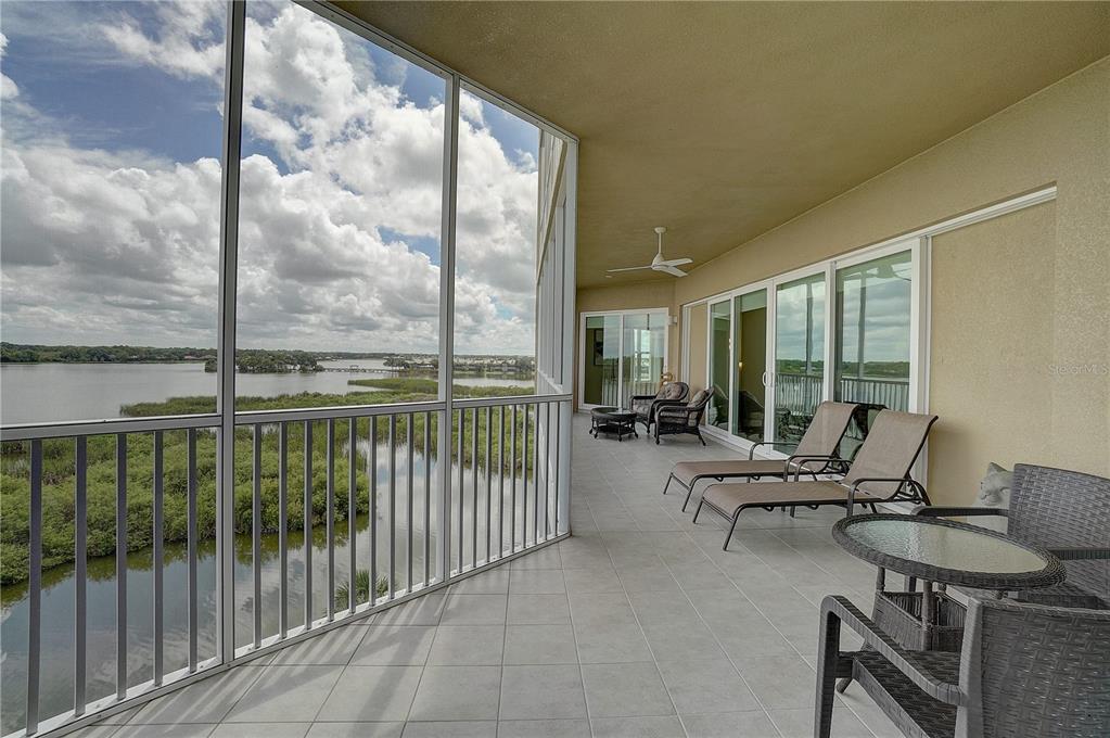 a living room with furniture and floor to ceiling windows