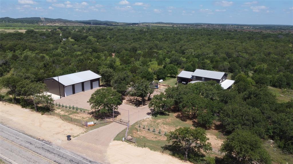 an aerial view of a house with a yard