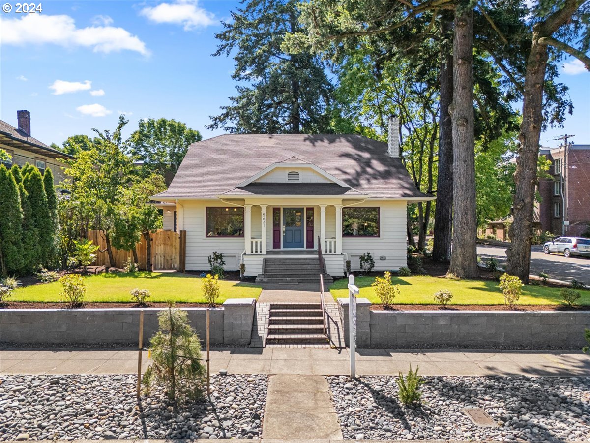 a front view of a house with swimming pool and yard