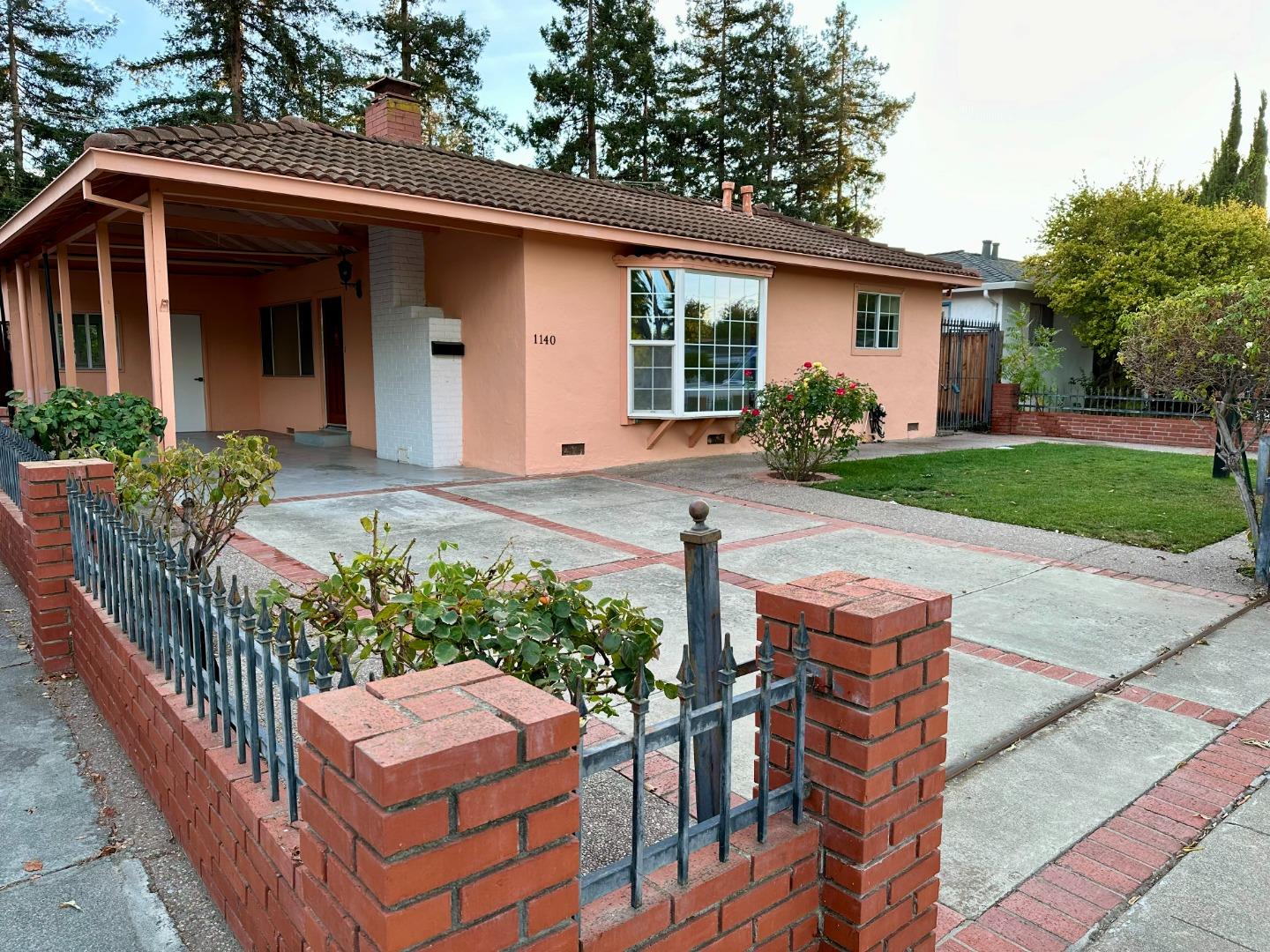 a front view of house with a garden and patio