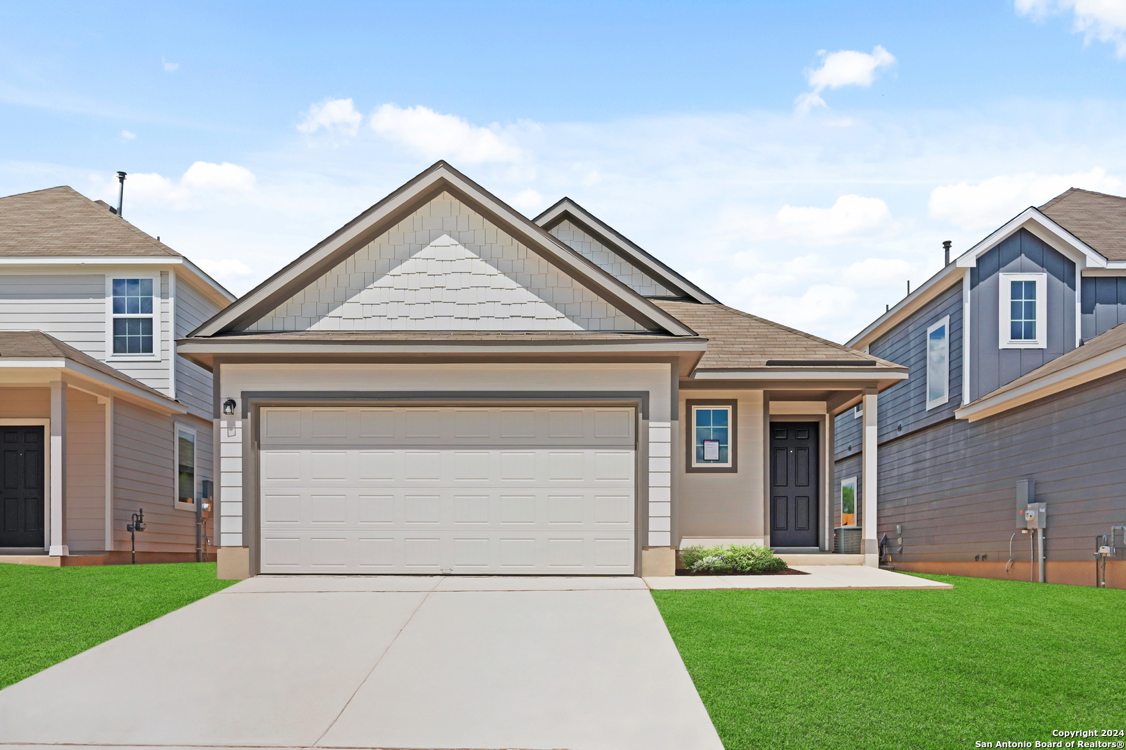 a front view of a house with a yard and garage