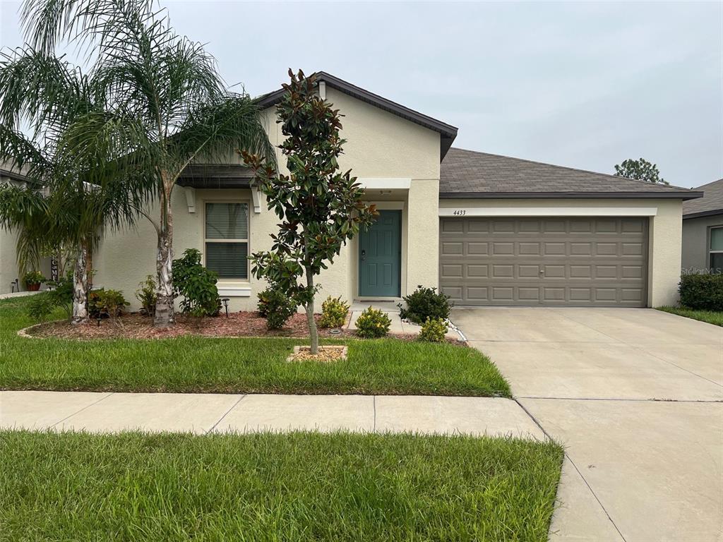 a front view of a house with a yard and garage