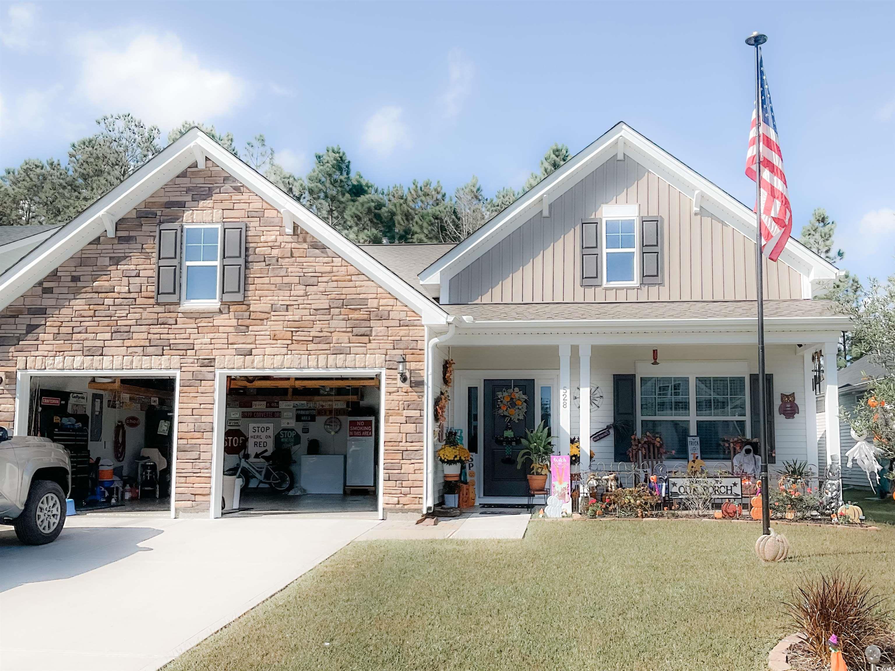 View of front facade with a porch, a garage, and a