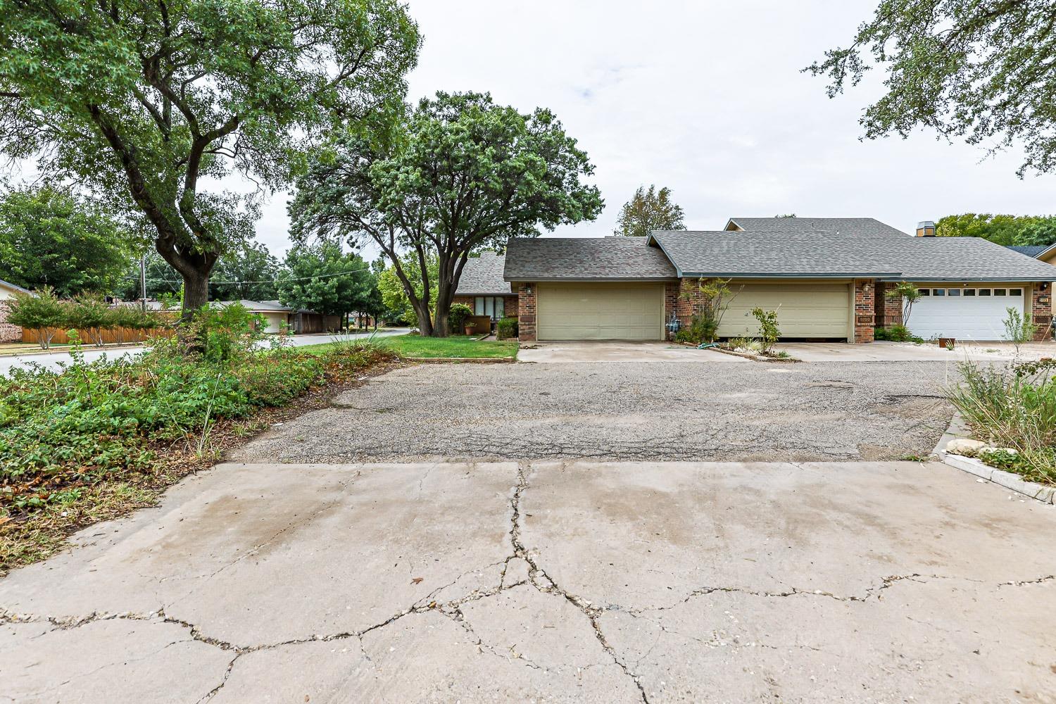 a front view of a house with a yard and a garage