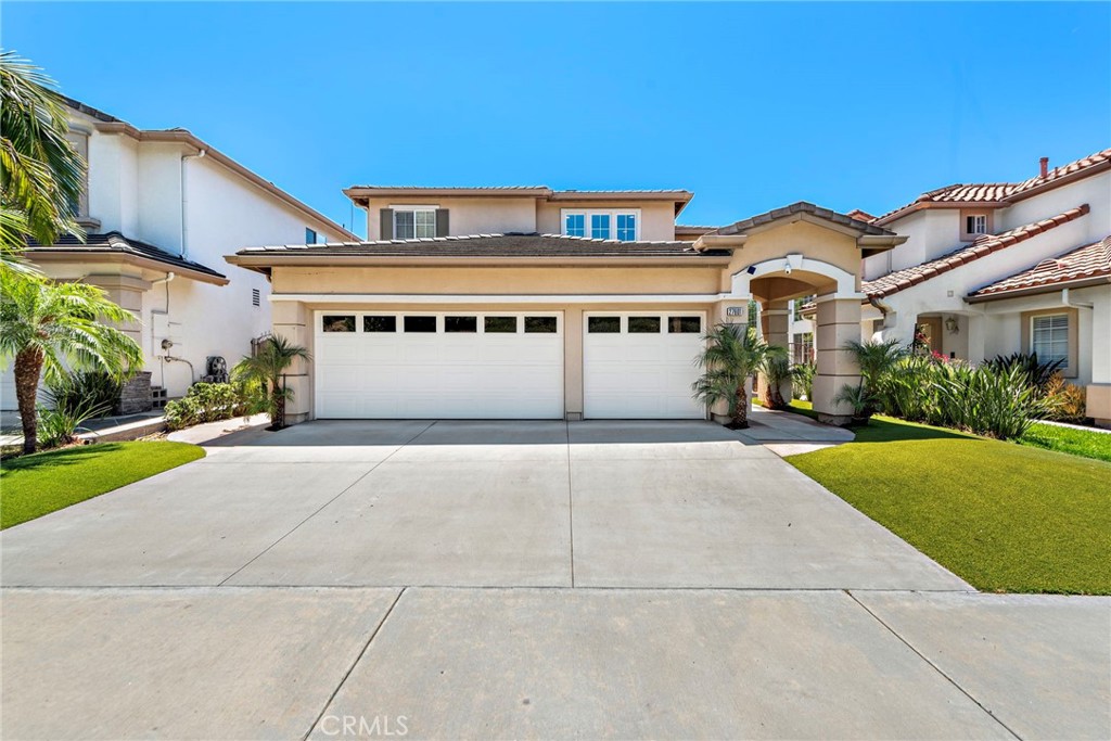 a front view of a house with a yard and garage