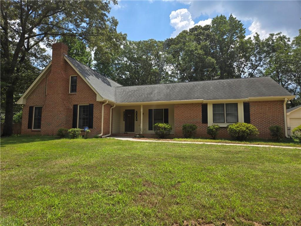 a front view of house with yard and green space