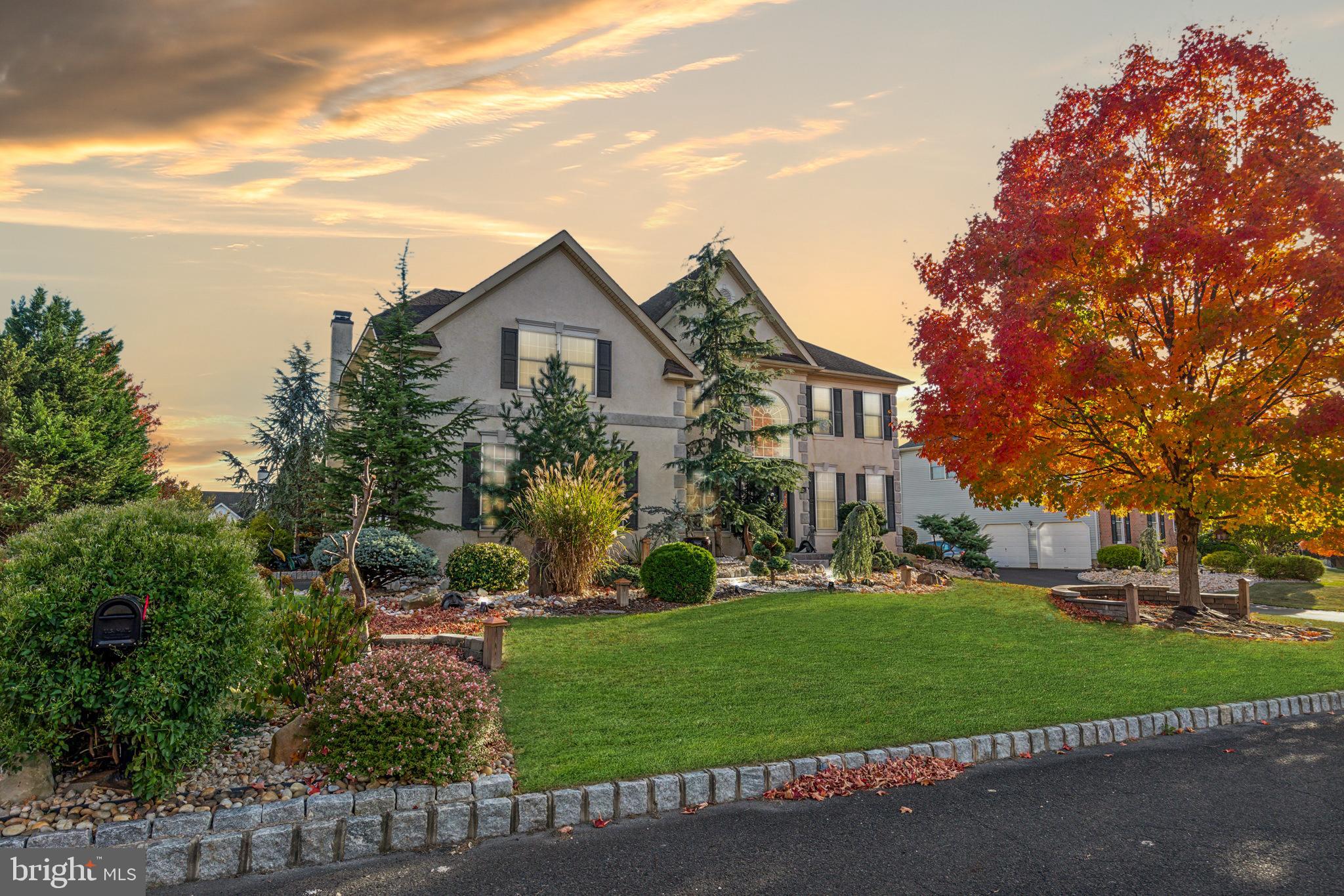 a view of house with yard and green space