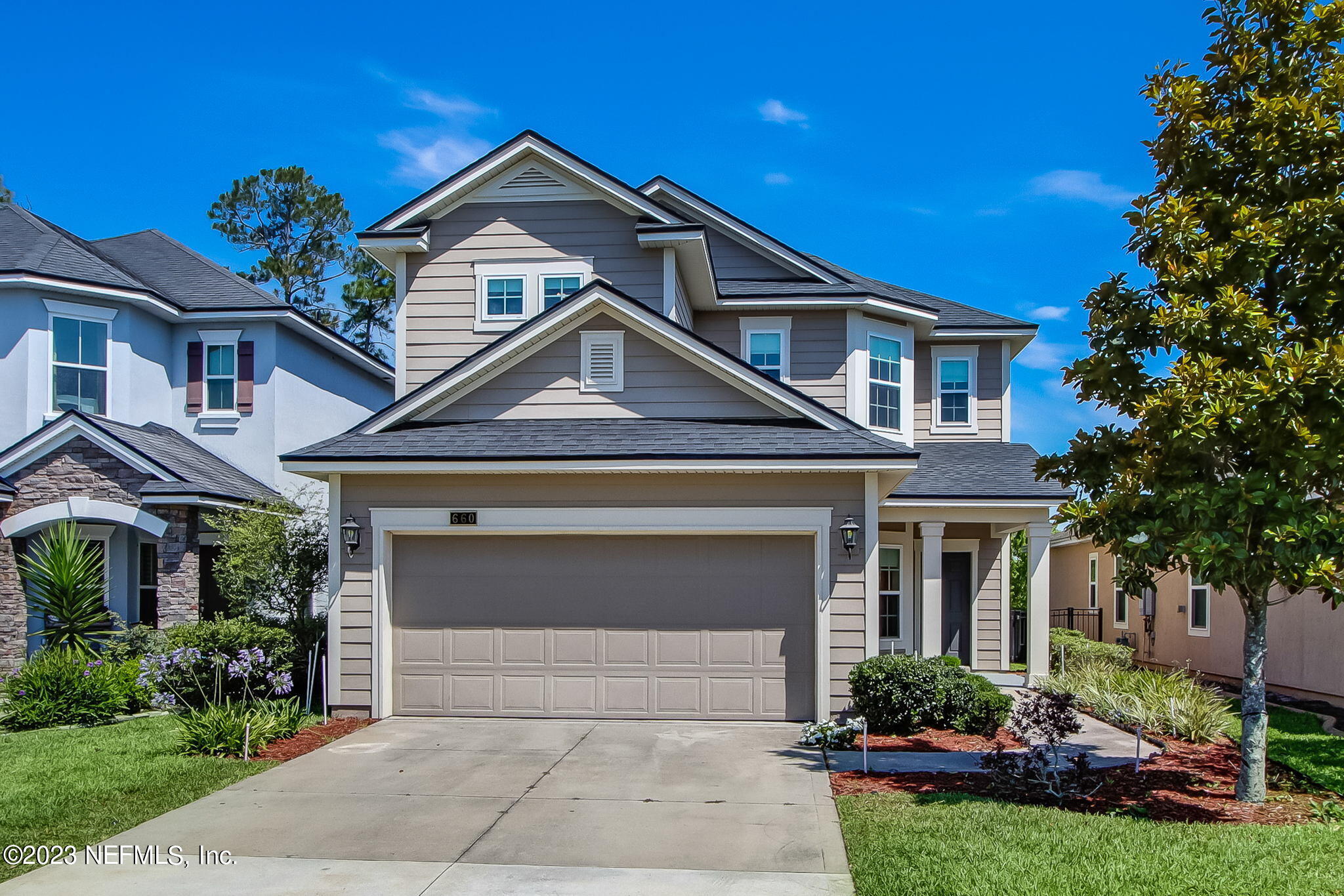 a front view of a house with a yard and garage