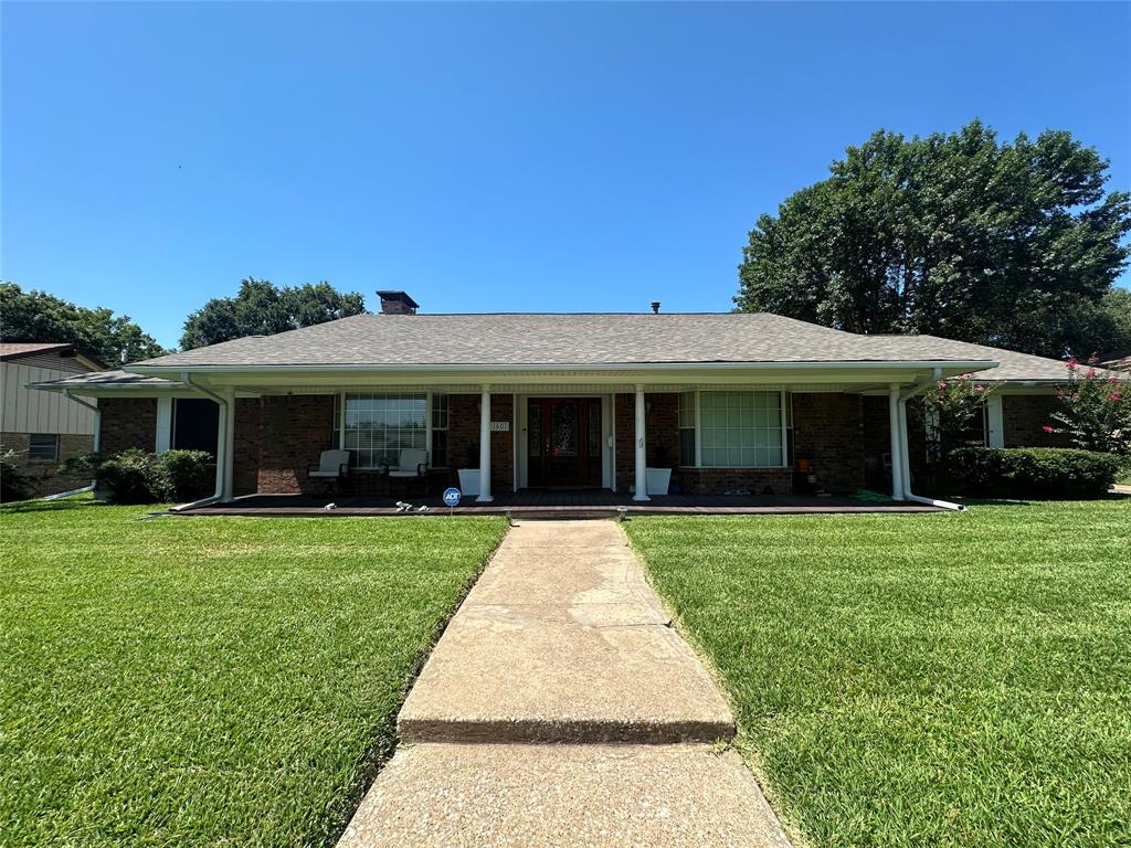 a front view of a house with a yard and porch