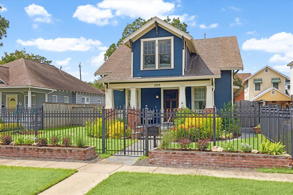 a front view of a house with a garden and plants