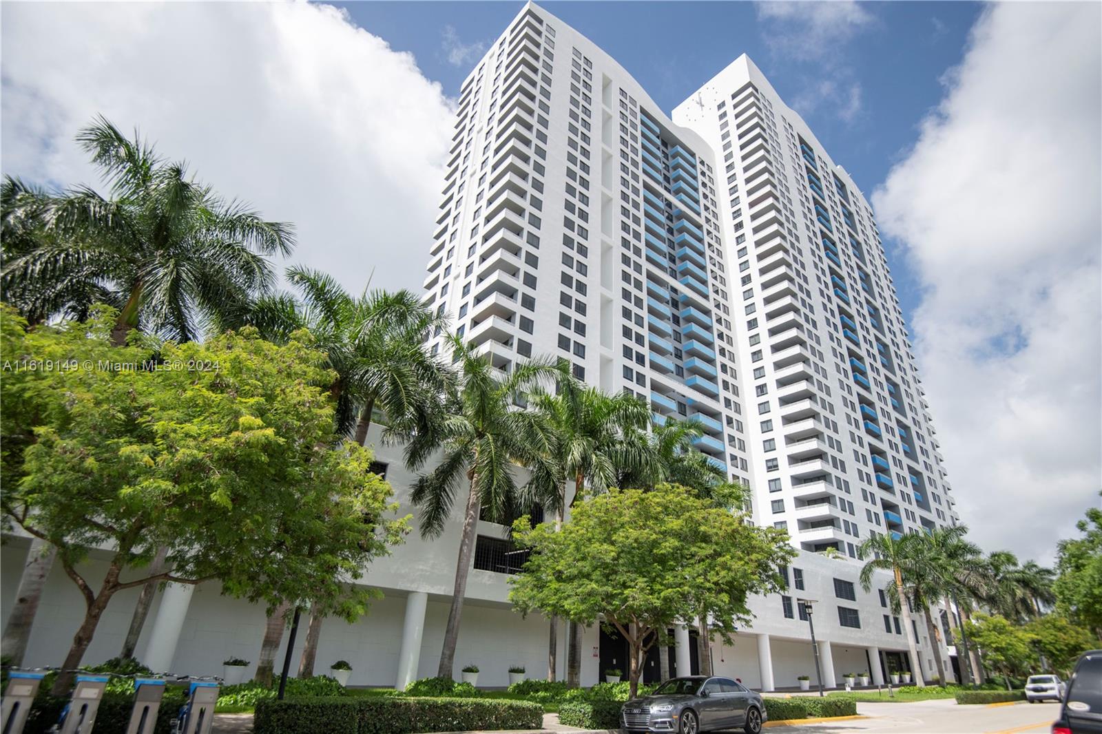 a view of a tall building next to a road