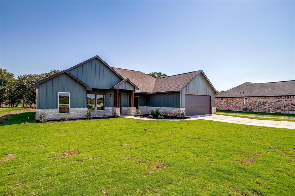 a front view of a house with a yard and a garage