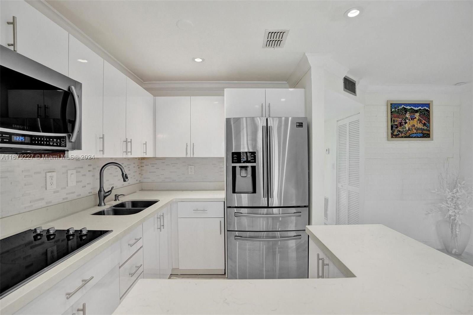 a kitchen with a refrigerator sink and microwave