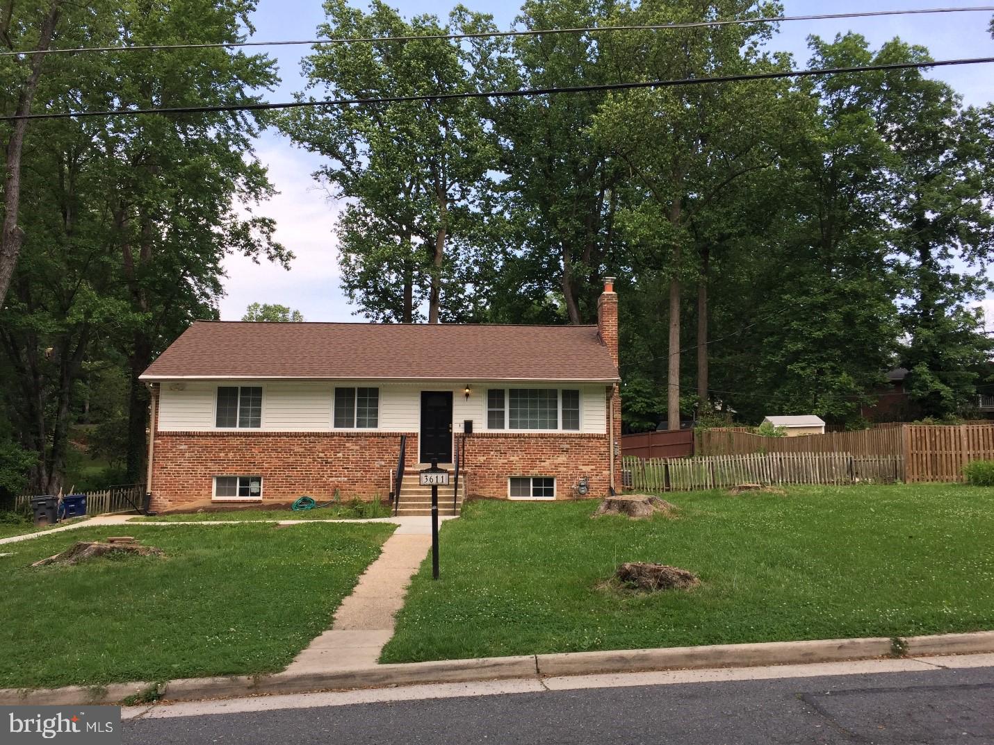 a front view of a house with a garden and yard