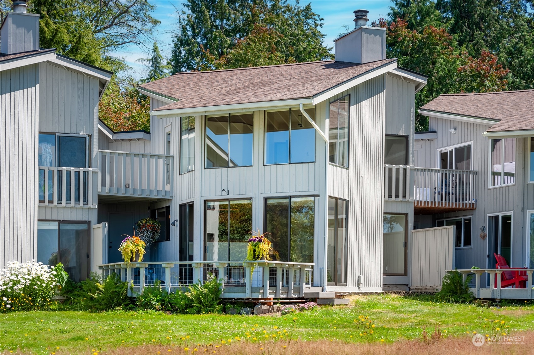 a view of an house with backyard and sitting area