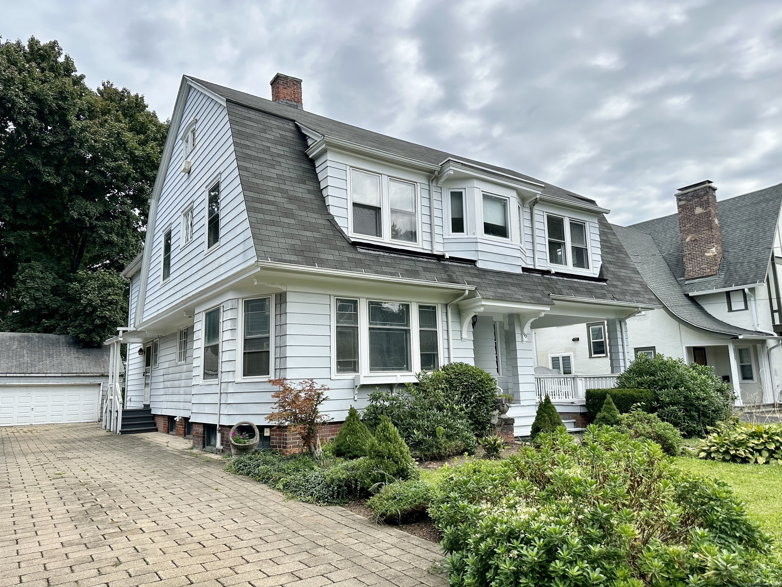 a front view of a house with garden