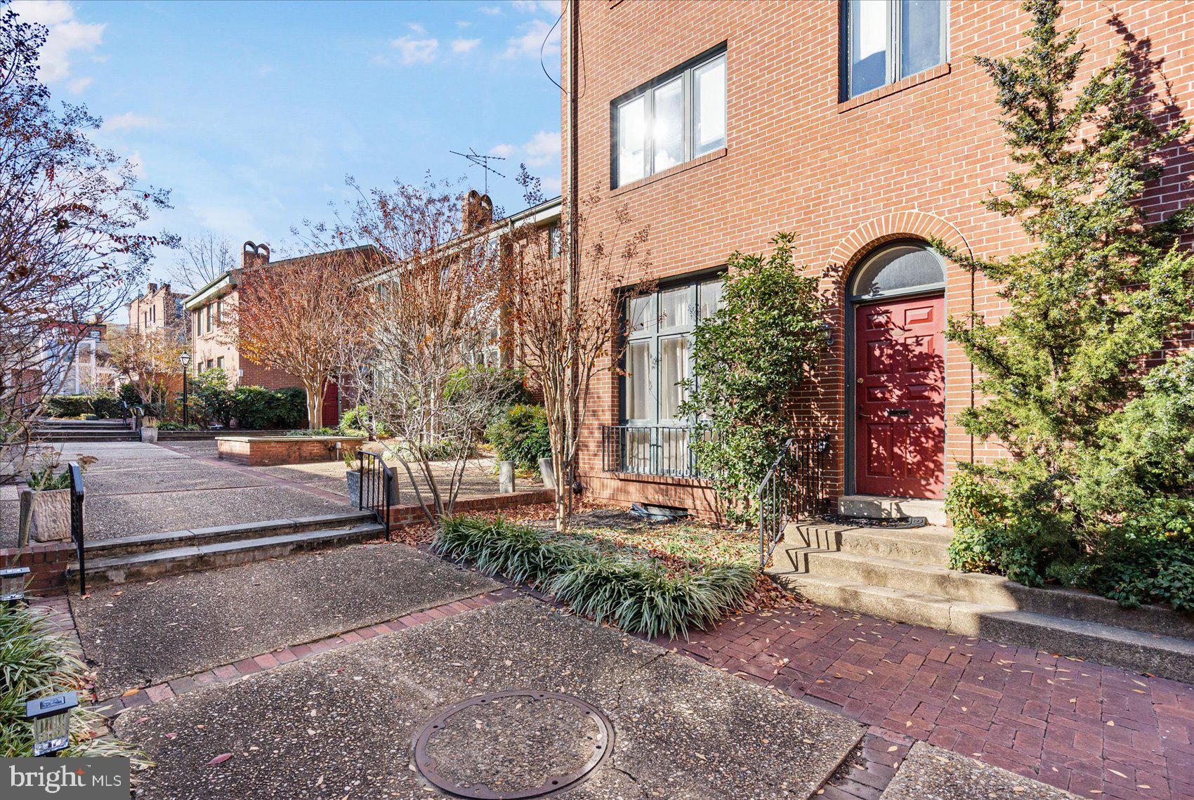 a view of a brick building next to a road