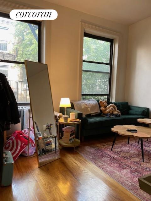 a living room with furniture window and wooden floor