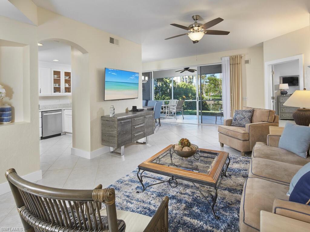 Bright and airy living room opens to the kitchen, dining area and lanai.